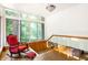 Bright sunroom featuring large windows with views of nature, a cozy rocking chair, and tile floors at 922 Barton Woods Ne Rd, Atlanta, GA 30307