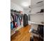 Walk-in closet with custom shelving, hardwood floors, and ample storage for clothes and accessories at 922 Barton Woods Ne Rd, Atlanta, GA 30307