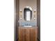 Chic bathroom with a wood vanity, modern mirror and sconces at 11554 Serenbe Ln, Chattahoochee Hills, GA 30268