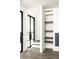Modern entryway featuring custom iron doors, hardwood floors, and built-in shelving at 11554 Serenbe Ln, Chattahoochee Hills, GA 30268
