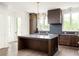 Well-appointed kitchen with large island, stainless appliances, and wood cabinetry at 11554 Serenbe Ln, Chattahoochee Hills, GA 30268