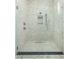Luxurious shower featuring stylish mosaic tilework and a frameless glass enclosure for a spa-like experience at 11554 Serenbe Ln, Chattahoochee Hills, GA 30268