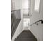 Modern staircase with black railing and hardwood steps leading to multiple levels at 11554 Serenbe Ln, Chattahoochee Hills, GA 30268