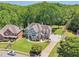 A gray stucco home with a basketball court sits nestled amongst lush green trees at 2645 Preston Ridge Ln, Dacula, GA 30019