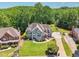 A beautiful home with a well manicured yard and basketball court; surrounded by lush trees at 2645 Preston Ridge Ln, Dacula, GA 30019