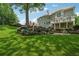 Expansive backyard features stone retaining wall and lush green lawn at 2645 Preston Ridge Ln, Dacula, GA 30019