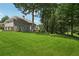 Expansive backyard with lush green lawn and mature trees, offering privacy and space at 2645 Preston Ridge Ln, Dacula, GA 30019