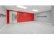Finished basement with red accent wall, tiled floor and modern lighting at 2645 Preston Ridge Ln, Dacula, GA 30019