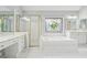 Bathroom featuring a soaking tub, walk-in shower and colorful stained glass window at 2645 Preston Ridge Ln, Dacula, GA 30019