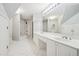 Bright bathroom with a dual sink vanity, large mirror, and shower-tub combination at 2645 Preston Ridge Ln, Dacula, GA 30019