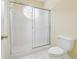 Clean bathroom with white shower stall and circular patterned window at 2645 Preston Ridge Ln, Dacula, GA 30019