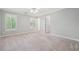 Spacious bedroom with neutral carpet, gray walls and natural light from two windows at 2645 Preston Ridge Ln, Dacula, GA 30019
