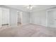 A bedroom with light gray walls, neutral carpet, and doors leading to a bathroom and closet at 2645 Preston Ridge Ln, Dacula, GA 30019