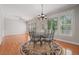 Bright breakfast nook showcasing hardwood floors, wrought iron table, and bright windows at 2645 Preston Ridge Ln, Dacula, GA 30019