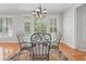 Breakfast nook with hardwood flooring and iron table near a window with shutters at 2645 Preston Ridge Ln, Dacula, GA 30019