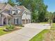 Home exterior features a three-car garage, basketball court, and professionally landscaped front yard at 2645 Preston Ridge Ln, Dacula, GA 30019