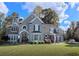 Elegant two-story home with stone and stucco exterior, manicured lawn, and mature trees at 2645 Preston Ridge Ln, Dacula, GA 30019