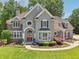 Stunning two-story home with lush landscaping, gray stucco and stone accents on a verdant lot at 2645 Preston Ridge Ln, Dacula, GA 30019