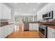Bright kitchen boasts stainless appliances, granite countertops, and ample cabinet space at 2645 Preston Ridge Ln, Dacula, GA 30019