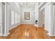 Open living room with hardwood floors, tall ceilings, fireplace, and large windows; great natural light at 2645 Preston Ridge Ln, Dacula, GA 30019