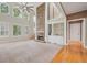 Spacious living room featuring a stone fireplace, high ceilings, and large windows at 2645 Preston Ridge Ln, Dacula, GA 30019
