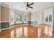 Light-filled living room featuring hardwood floors, large windows, and French doors; elegant trim at 2645 Preston Ridge Ln, Dacula, GA 30019