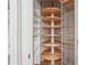 Walk-in pantry with wooden shelves and wire baskets for optimal storage at 2645 Preston Ridge Ln, Dacula, GA 30019