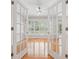 Sun-filled sunroom with hardwood floors viewed through interior glass french doors at 2645 Preston Ridge Ln, Dacula, GA 30019