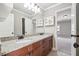 Bathroom vanity with double sinks, granite countertop, and a large mirror with decorative cabinets at 2656 Old Norcross Rd, Tucker, GA 30084