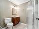 Well-lit bathroom featuring a glass-door shower, vanity with sink, and a standard toilet at 2656 Old Norcross Rd, Tucker, GA 30084