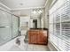 Bathroom with a shower-tub, granite vanity, and a large window providing natural light at 2656 Old Norcross Rd, Tucker, GA 30084