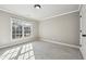 Neutral bedroom with carpeted floors, natural lighting, and a view of the backyard through the window at 2656 Old Norcross Rd, Tucker, GA 30084