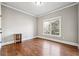 Bright bedroom with hardwood floors and a large window offering natural light at 2656 Old Norcross Rd, Tucker, GA 30084