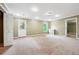 Spacious bonus room featuring neutral carpet, bright lighting, and a convenient exterior door at 2656 Old Norcross Rd, Tucker, GA 30084