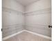Walk-in closet with sturdy shelving and carpeted flooring, offering ample storage space at 2656 Old Norcross Rd, Tucker, GA 30084