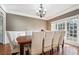 Elegant dining room with large windows and seating for eight at 2656 Old Norcross Rd, Tucker, GA 30084