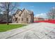 A long driveway leads to this home with a brick exterior and a bright red fence at 2656 Old Norcross Rd, Tucker, GA 30084