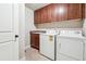 Functional laundry room featuring a sink, washer, dryer, and ample cabinet space at 2656 Old Norcross Rd, Tucker, GA 30084