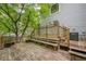 Expansive wooden deck with a built-in bench, surrounded by trees and foliage at 2663 Marcia Dr, Lawrenceville, GA 30044