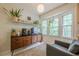 Inviting living room nook with plants, modern cabinet, and large bay window at 2663 Marcia Dr, Lawrenceville, GA 30044
