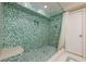 Unique shower featuring a mosaic of green and white tiles, a shower bench, and a recessed shelf at 2663 Marcia Dr, Lawrenceville, GA 30044