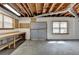 Unfinished basement with exposed ceiling and concrete walls with window access at 3003 Heavenly Ln, Snellville, GA 30078