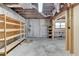 Unfinished basement with exposed ceiling, concrete walls, and wooden shelving at 3003 Heavenly Ln, Snellville, GA 30078