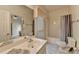 Bright bathroom featuring a vanity with a sink, toilet, and a shower-tub combo with a gray shower curtain at 3003 Heavenly Ln, Snellville, GA 30078