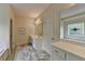 Sun-filled bathroom featuring a soaking tub, marble floors, and double sink vanity at 3003 Heavenly Ln, Snellville, GA 30078