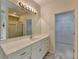 Spacious bathroom featuring double vanity sinks and a separate walk-in closet, offering both elegance and convenience at 3003 Heavenly Ln, Snellville, GA 30078