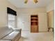 The bedroom features a ceiling fan, striped sofa, closet, and a bookshelf, perfect for comfort and storage at 3003 Heavenly Ln, Snellville, GA 30078