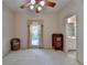 This bedroom features neutral carpeting, a ceiling fan, and a double window at 3003 Heavenly Ln, Snellville, GA 30078