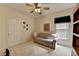 Cozy bedroom with neutral carpet, a ceiling fan, and a striped sofa, offering a comfortable and versatile space at 3003 Heavenly Ln, Snellville, GA 30078