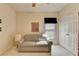 A view of the cozy bedroom, featuring a ceiling fan and a striped sofa near the window at 3003 Heavenly Ln, Snellville, GA 30078